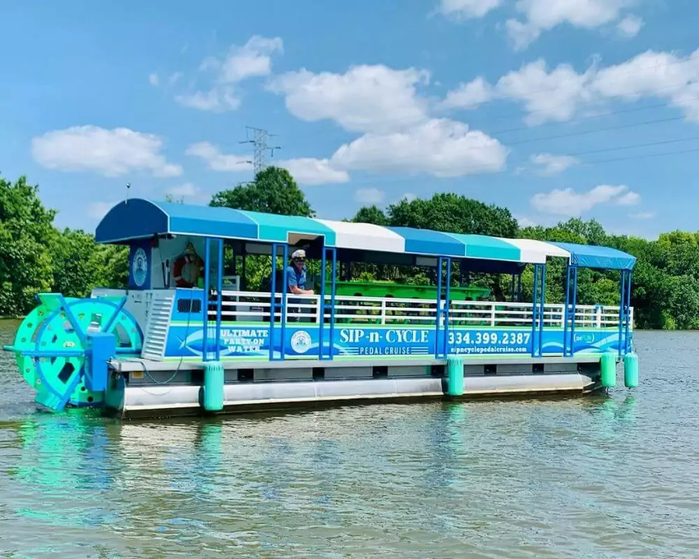 green and blue sip n cycle pedal cruiser on the water 2